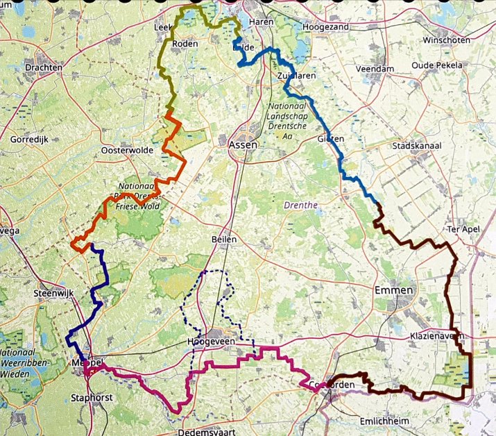 A map of the Drenthe region in the Netherlands, highlighting various routes in different colors, including orange, blue, and purple, with marked locations such as Emmen, Assen, and Oosterwolde.