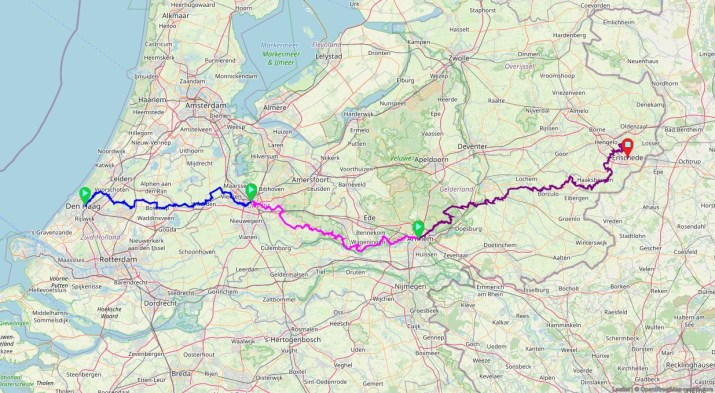 A map of the Netherlands showing a route highlighted in blue and pink, connecting various locations, including Den Haag and Enschede.